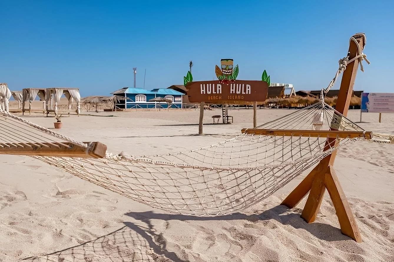Hammock and Hula Hula Beach Island sign overlooking the beach club