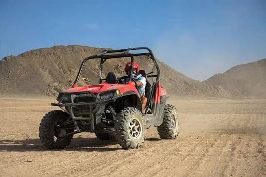 Red two-seat buggy in the desert
