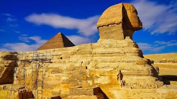 Close view of the Great Sphinx of Giza with a pyramid visible behind it