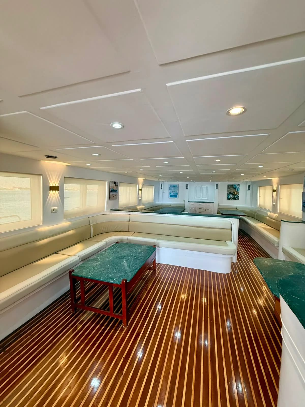 Comfortable interior seating lounge aboard the VIP sunset cruise yacht