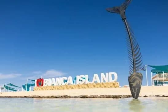 Bianca Island sign beside a mermaid-tail sculpture on the waterline
