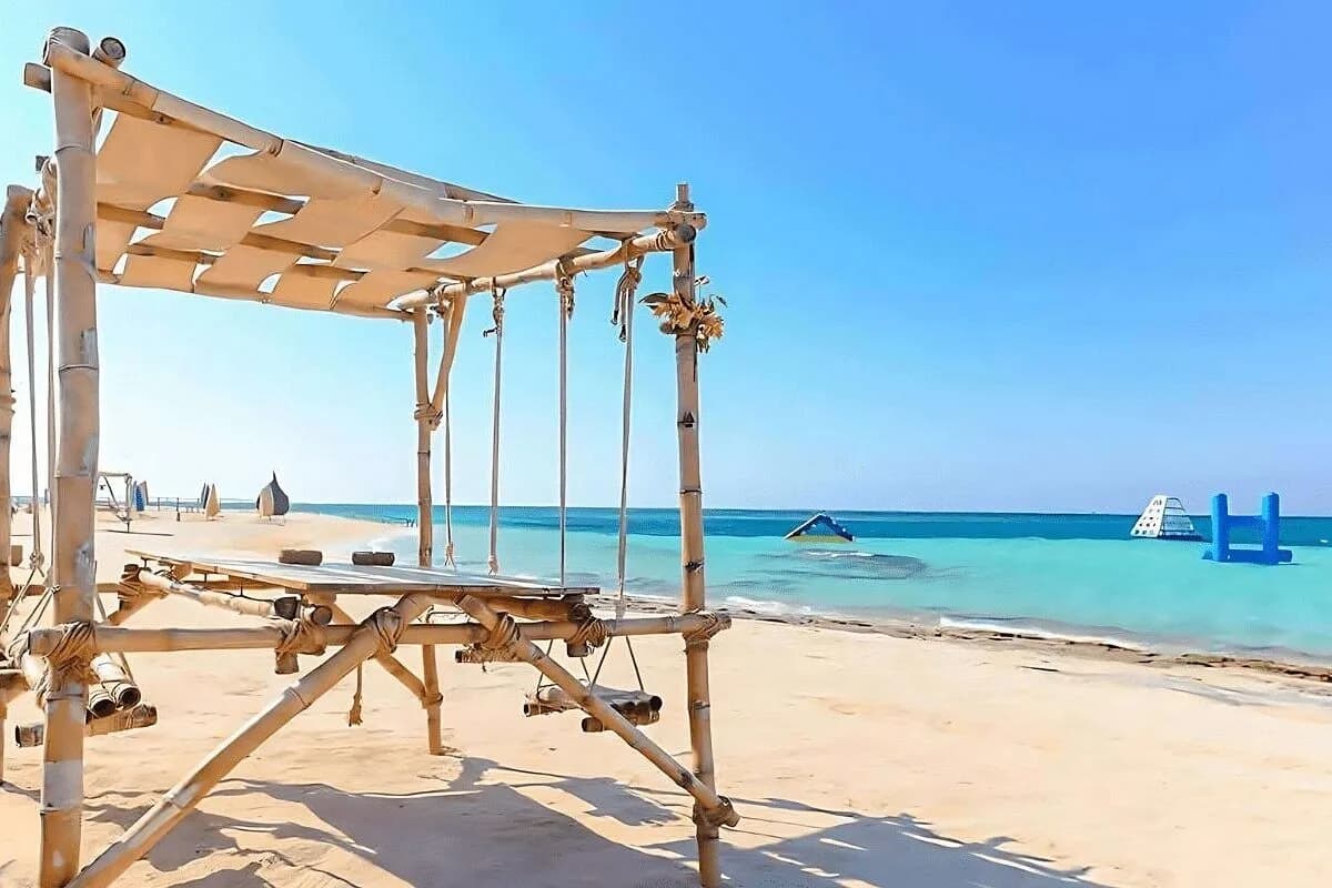 Bamboo beach cabana overlooking the turquoise water and inflatable water park at Paradise Island