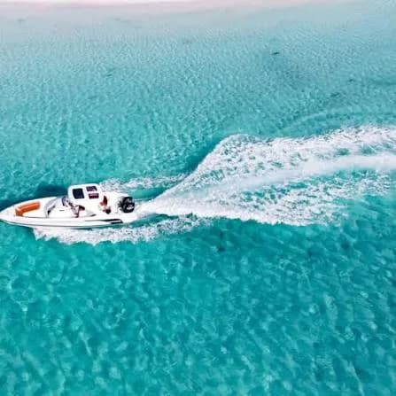 Aerial view of a private speedboat cruising across turquoise Red Sea water near Hurghada