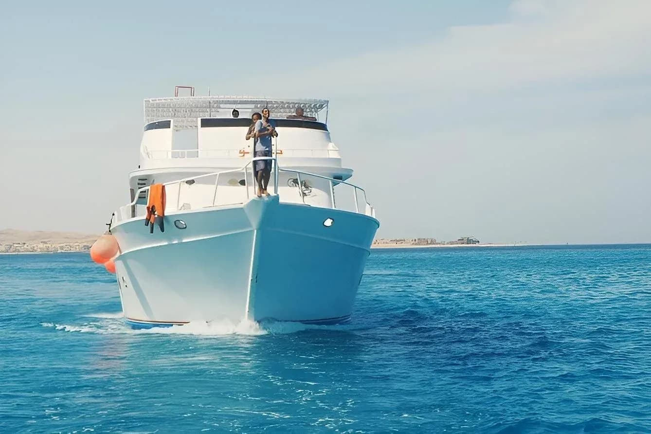 Crew members on the bow of the cruise boat heading out to sea