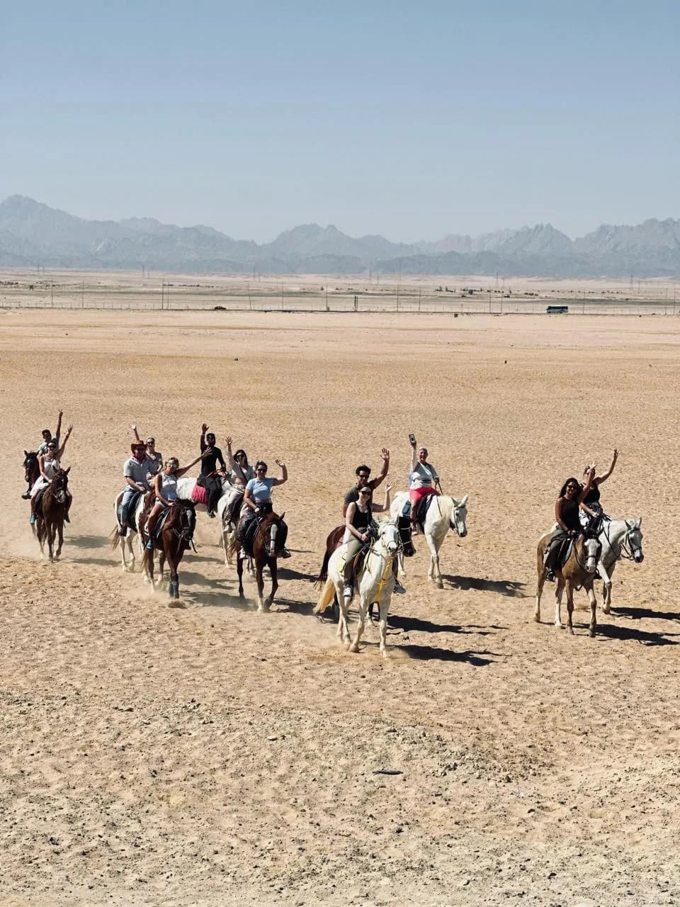 Group riding horses through the desert