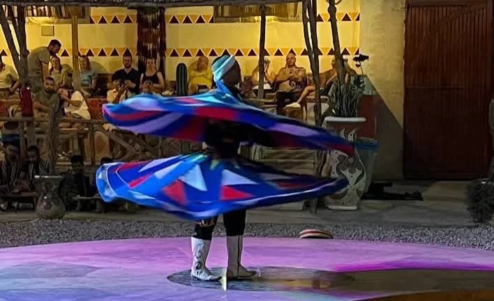 Tanoura dancer spinning in a colourful skirt during the evening show