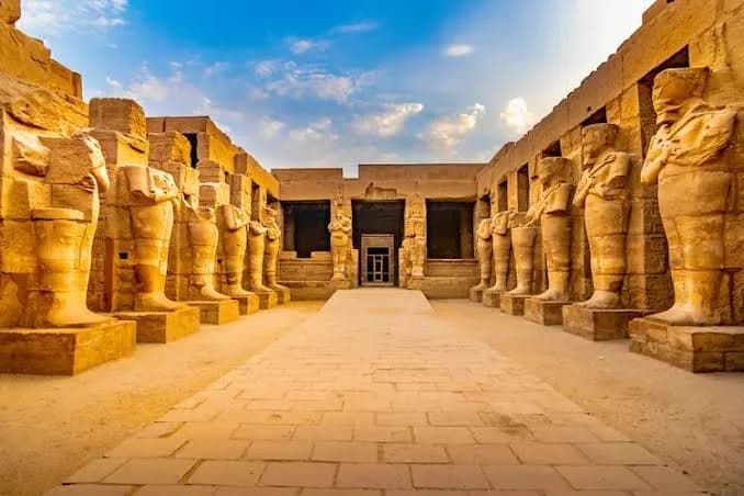 Twin rows of Osiride statues lining a courtyard at Karnak Temple