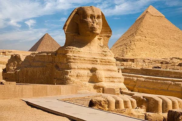 The Great Sphinx of Giza with the Pyramids of Giza in the background