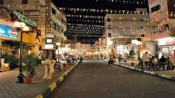 Local Hurghada market street at night with lights and shops