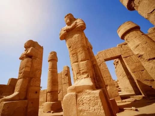 Osiride pillar statue at Karnak Temple against a clear blue sky