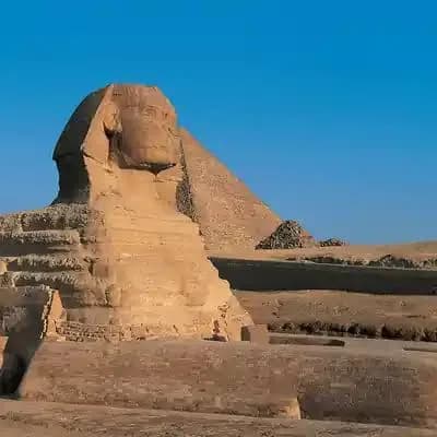 Close-up of the Great Sphinx of Giza with a pyramid in the background