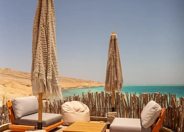 Lounge chairs and umbrellas overlooking the turquoise sea at Ozirea Island