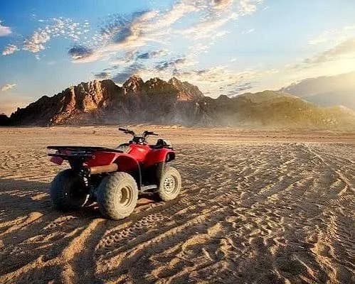 Quad bike parked in the Marsa Alam desert with mountains at sunset