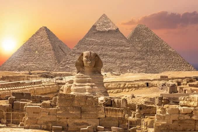 Great Sphinx and Pyramids of Giza at sunset