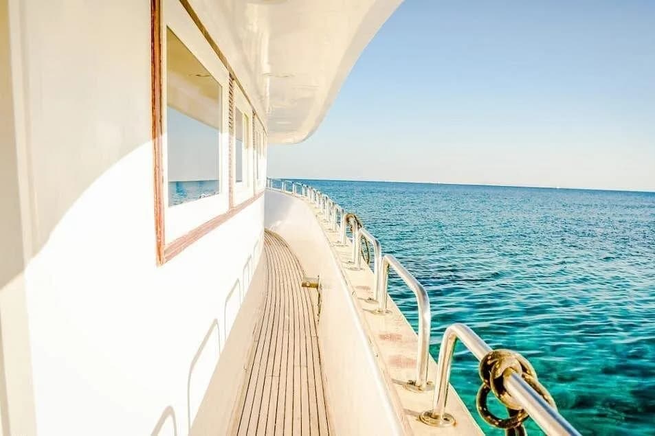 Orange Bay Island cruise boat anchored off Hurghada with snorkelers in the water